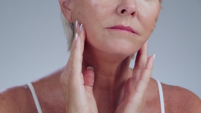 Woman looking critically at her skin and skincare.