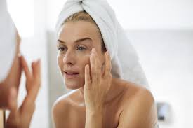 Woman looking at her complexion in the mirror