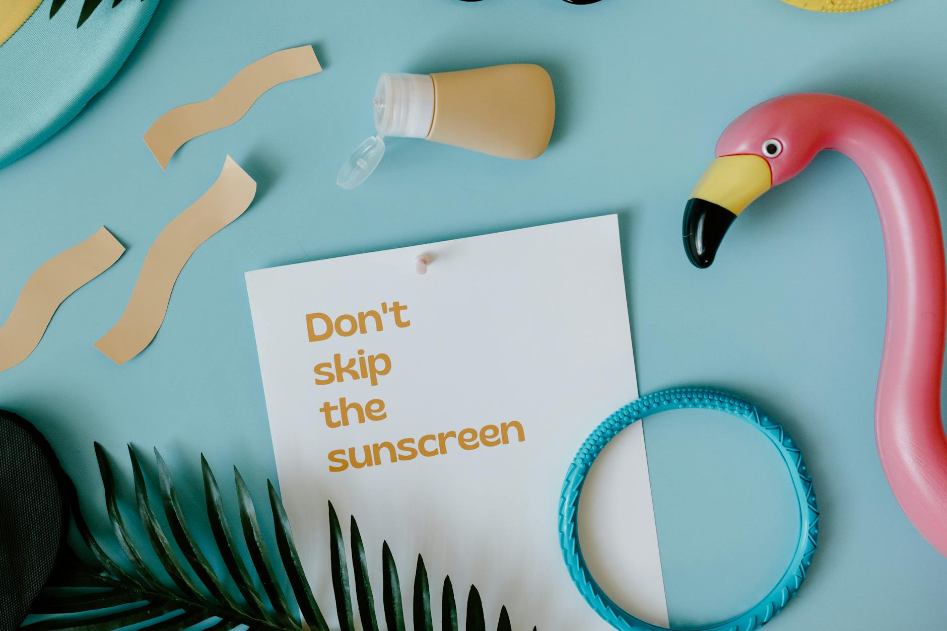 sunscreen over card with skin cancer awareness slogan